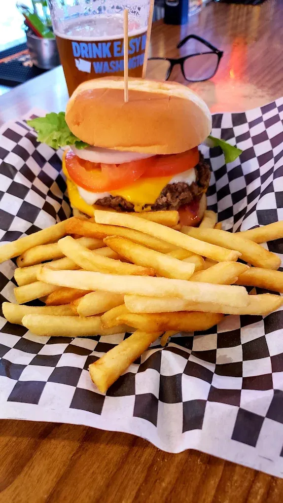 Double cheeseburger stacked high with a side of fries at Old Mill Tavern in Peshastin, WA