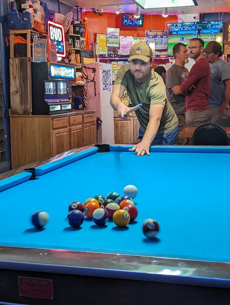 Player lining up a shot on the blue pool table at Old Mill Tavern in Peshastin, WA