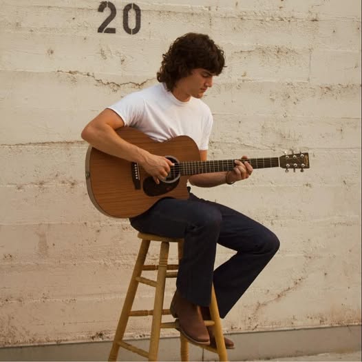 Beau Warren playing acoustic guitar on a stool at Old Mill Tavern in Peshastin, WA