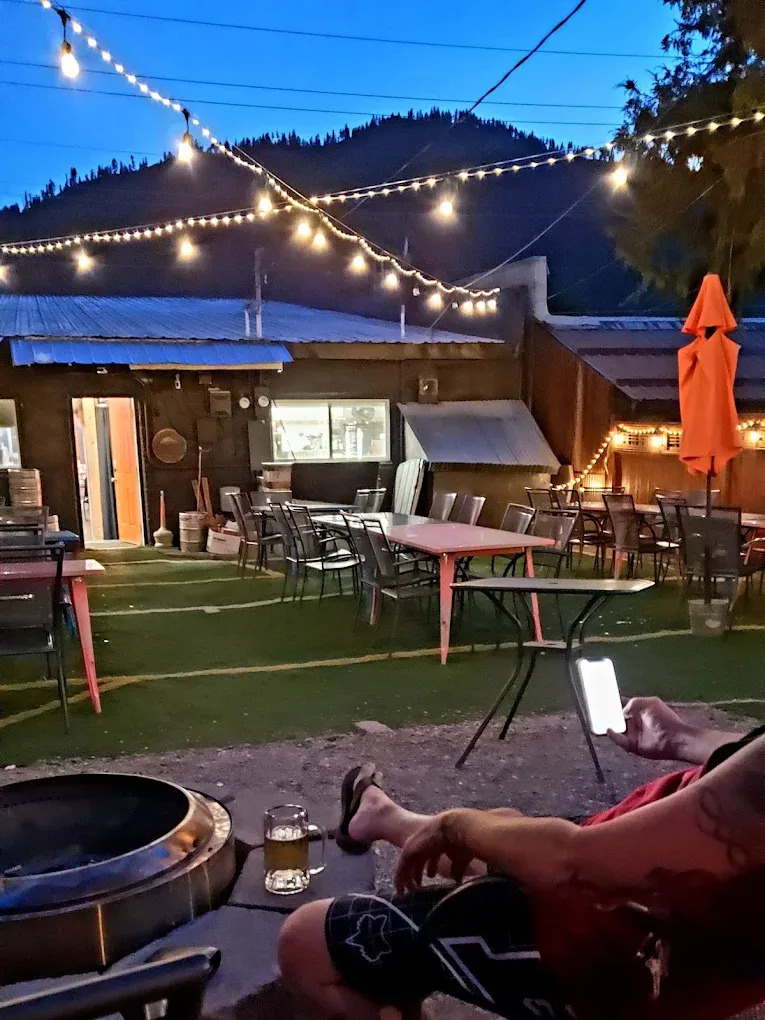 String lights over the outdoor patio at dusk with a fire pit at Old Mill Tavern in Peshastin, WA