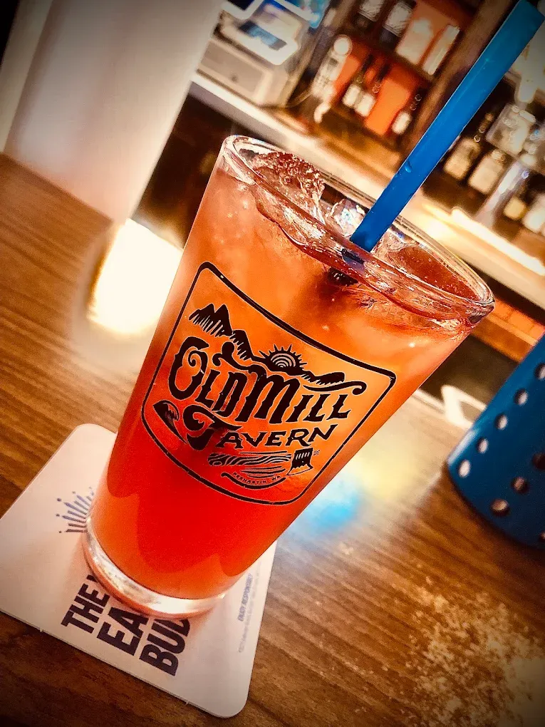 Old Mill Tavern branded tumbler filled with a red cocktail in Peshastin, WA