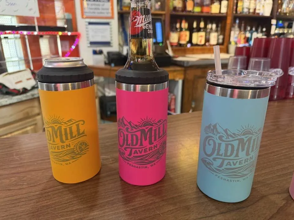 Old Mill Tavern branded tumblers in three colors on the bar in Peshastin, WA