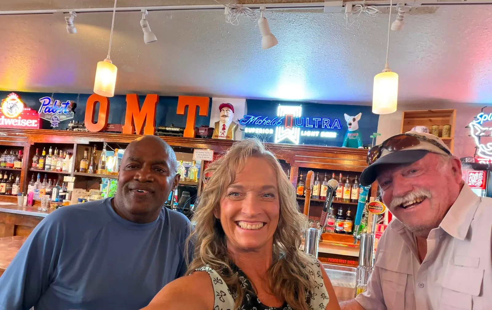 Mark and Wendi Burwell, owners of Old Mill Tavern in Peshastin, WA, with a regular at the bar