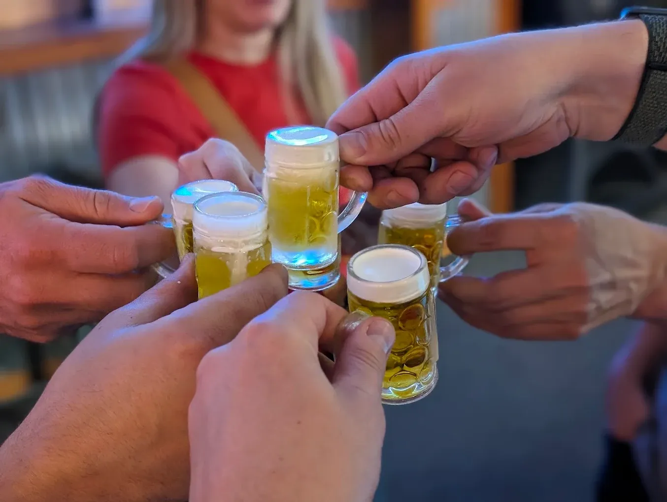 Friends clinking small beer glasses together at Old Mill Tavern in Peshastin, WA